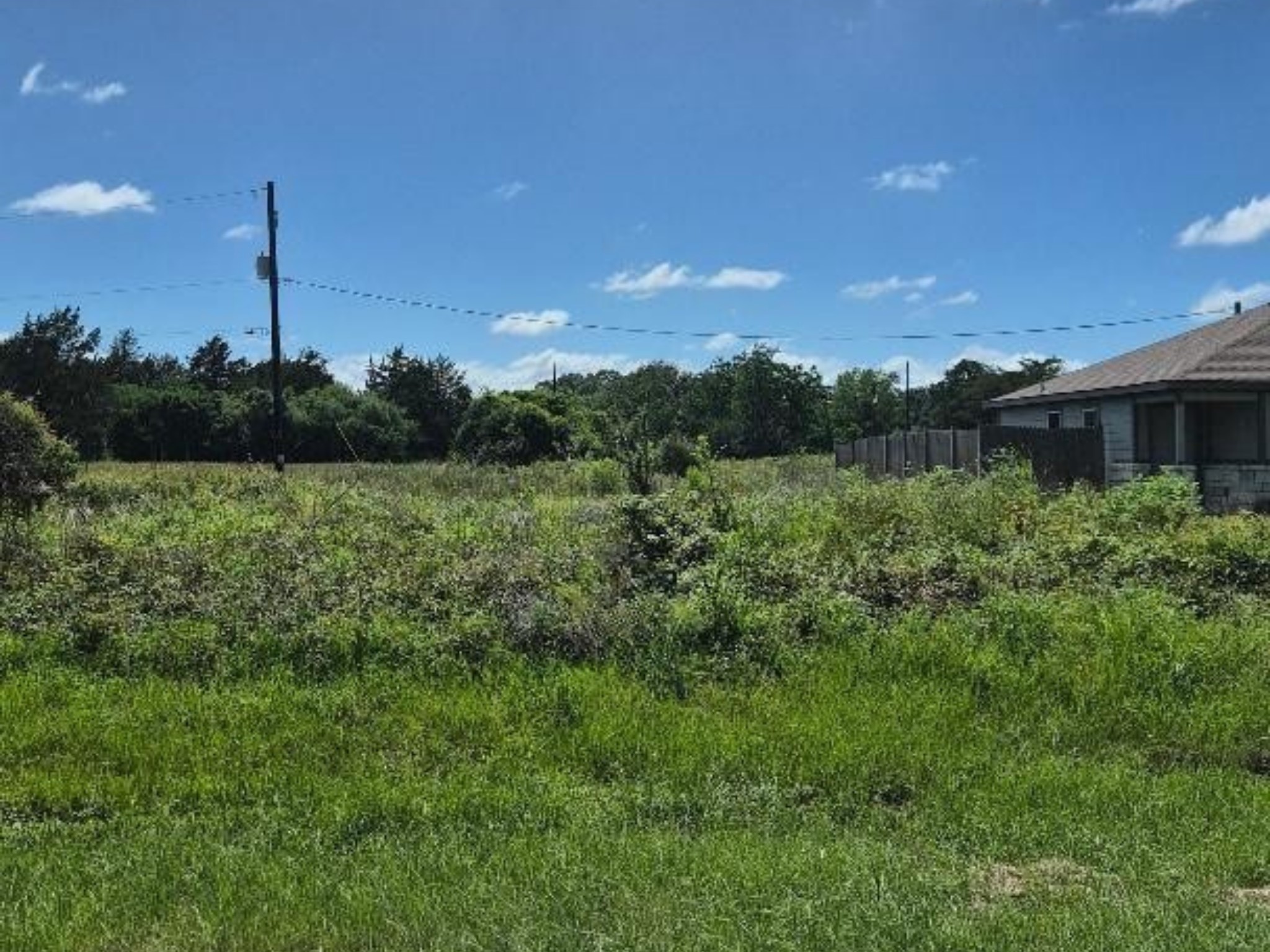 Hempstead City Lot that faces a spacious private ranch.  City Amenities include Playground, Splashpad, Baseball Fields, Basketball Court, Volleyball and Walking Trails