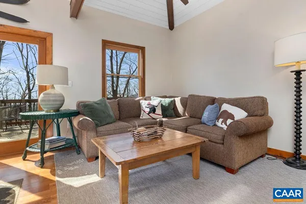 a view of a hallway with wooden floor and stairs
