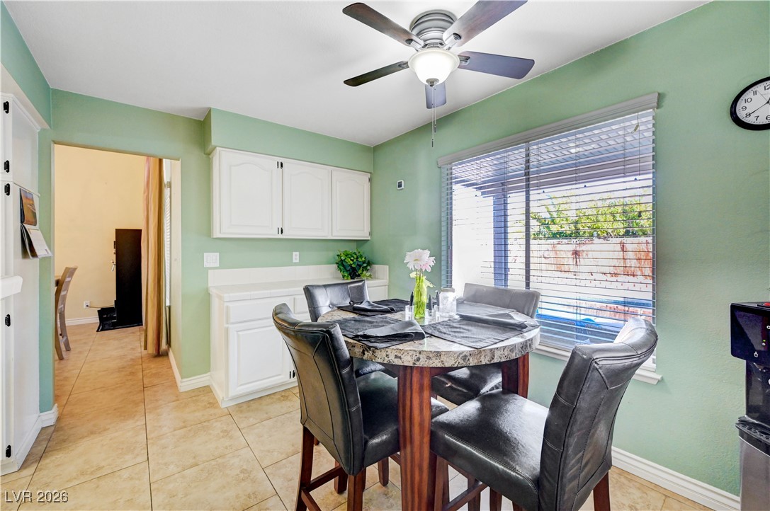 14 Barton Spring Circle Henderson, NV 89074 - Photo 15 of 64 Dining room with light tile patterned flooring and a ceiling fan