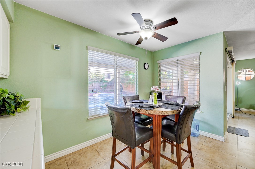 14 Barton Spring Circle Henderson, NV 89074 - Photo 20 of 64 Dining room featuring plenty of natural light, light tile patterned flooring, and a ceiling fan