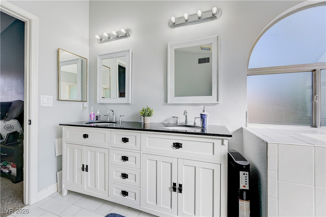 14 Barton Spring Circle Henderson, NV 89074 - Photo 35 of 64 Full bathroom featuring double vanity and connected bathroom