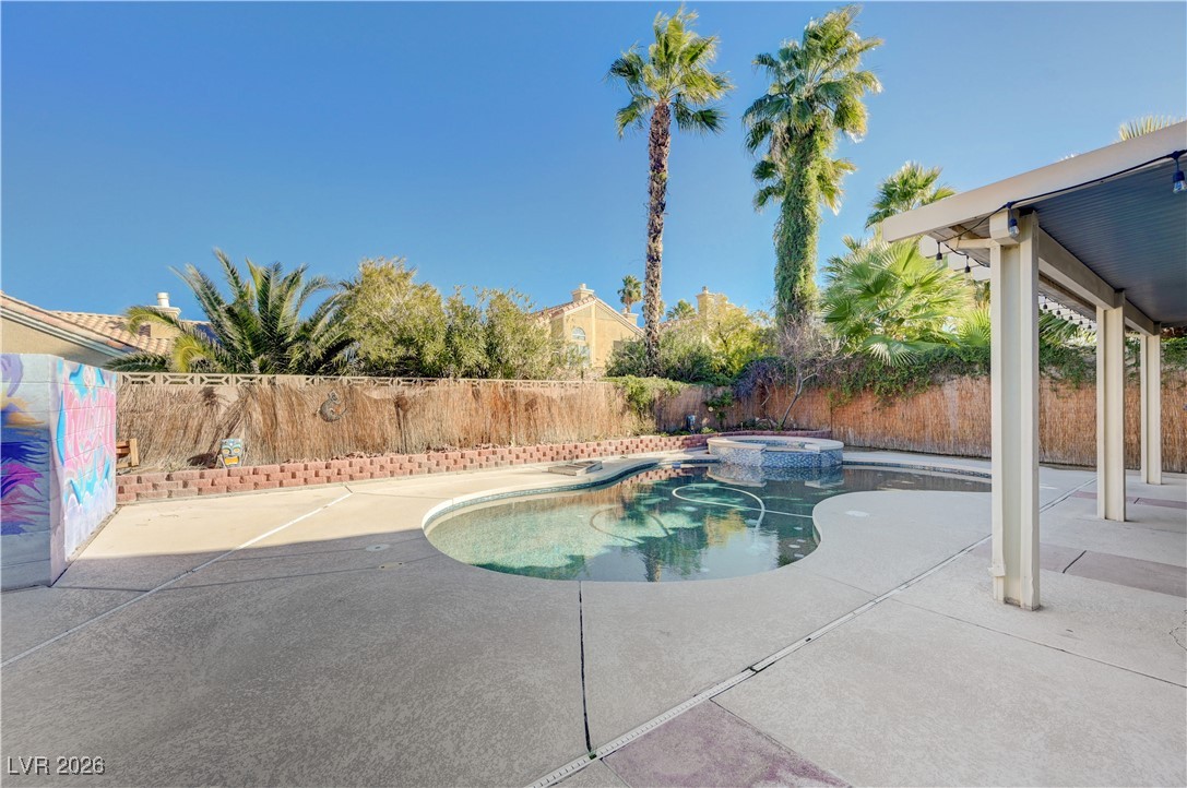 14 Barton Spring Circle Henderson, NV 89074 - Photo 44 of 64 View of swimming pool featuring a patio area, a fenced backyard, and a pool with connected hot tub
