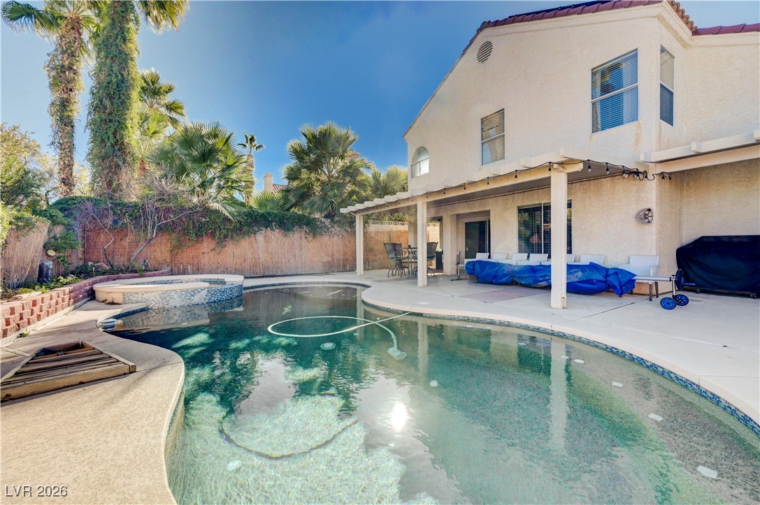 14 Barton Spring Circle Henderson, NV 89074 - Photo 45 of 64 View of swimming pool featuring a patio area, a fenced backyard, a pool with connected hot tub, grilling area, and an outdoor hangout area