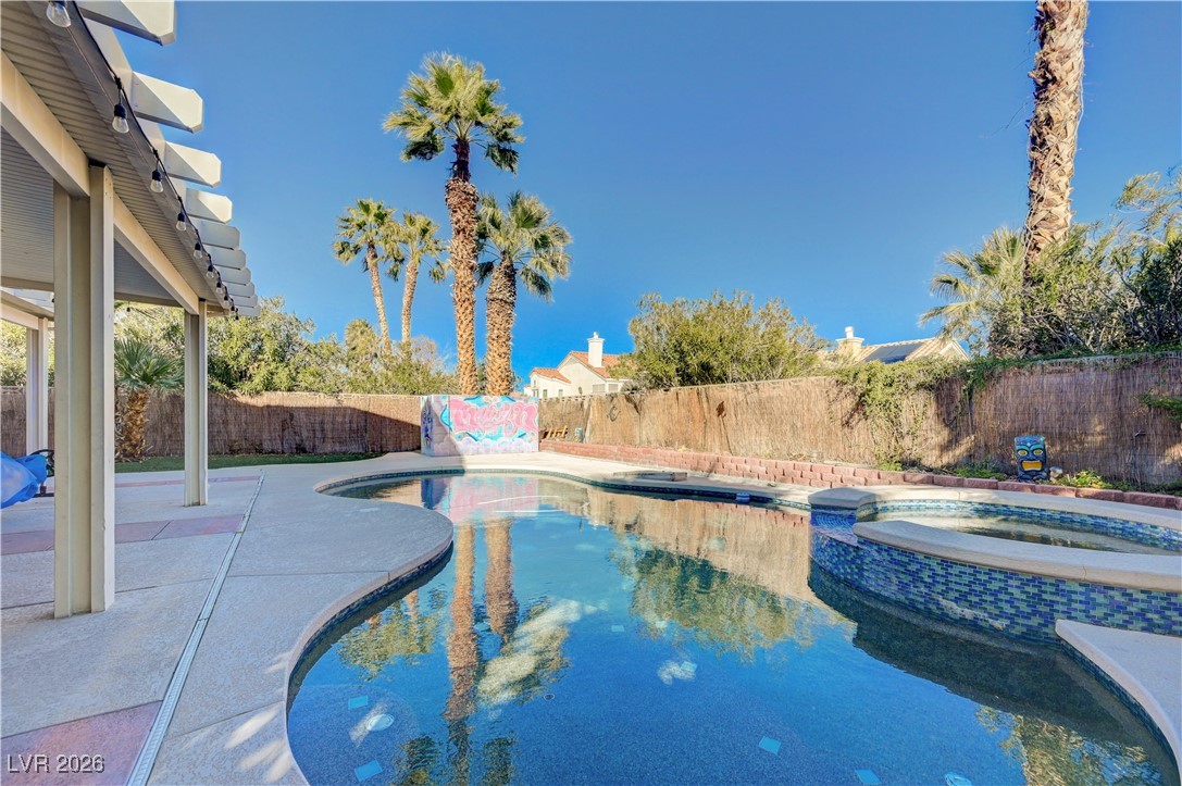 14 Barton Spring Circle Henderson, NV 89074 - Photo 48 of 64 View of pool featuring a fenced backyard, a patio area, and a pool with connected hot tub