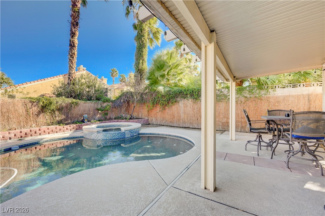 14 Barton Spring Circle Henderson, NV 89074 - Photo 53 of 64 View of pool with a patio area, a fenced backyard, a pool with connected hot tub, and outdoor dining area