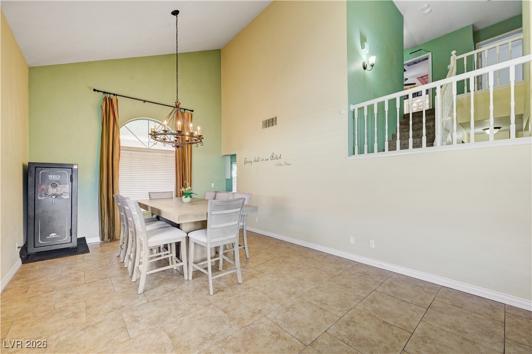 14 Barton Spring Circle Henderson, NV 89074 - Photo 7 of 64 Dining room with high vaulted ceiling and a chandelier