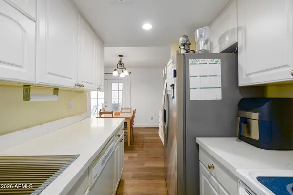 a kitchen with kitchen island a stove a refrigerator and a sink