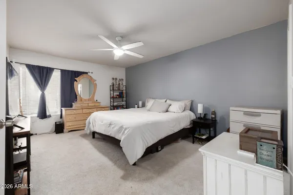 a bedroom with a large bed and a tv