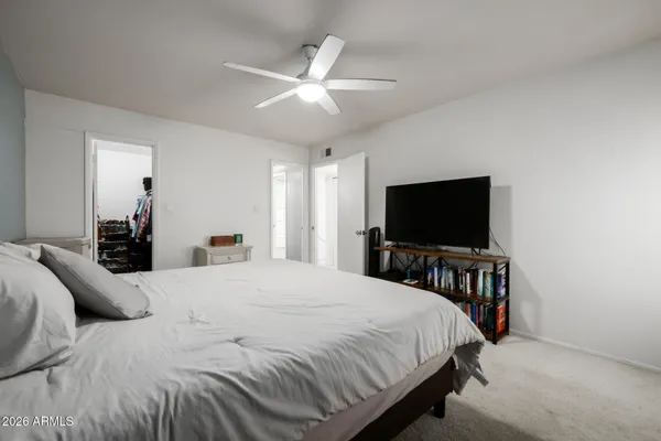 a bedroom with a bed and a flat screen tv