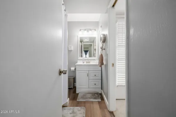 a view of a hallway with closet and wooden floor