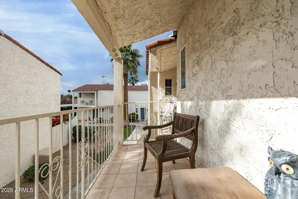 a view of a balcony with wooden floor