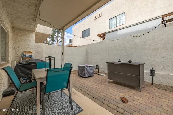 a view of a patio with table and chairs and potted plants