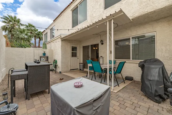 a view of a patio with a table and a chair