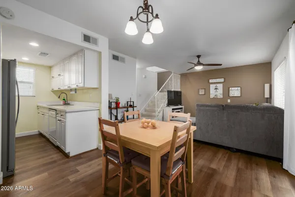 a kitchen with a table chairs refrigerator and microwave