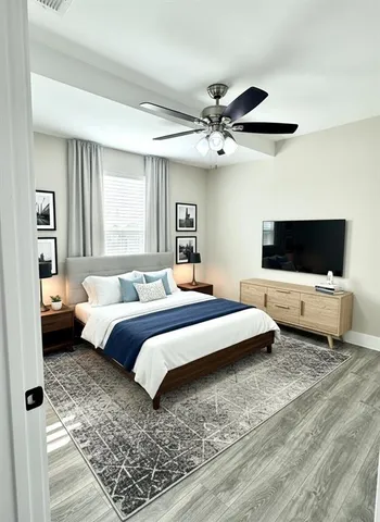 a bedroom with a bed and a flat screen tv