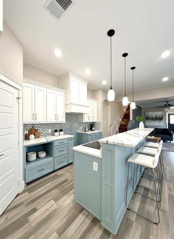 6164 Highway 289 Howe, TX 75459 - Photo 4 of 21 a kitchen with a stove a sink a kitchen island with wooden cabinets and floor