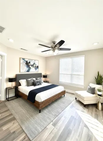 a bedroom with a bed and a large window