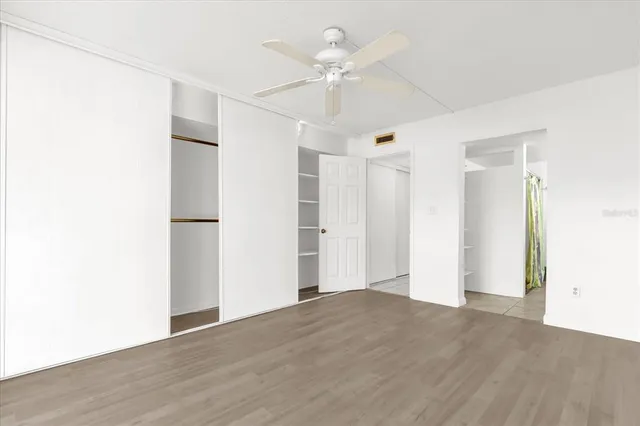 a bathroom with a toilet a sink a vanity and mirror