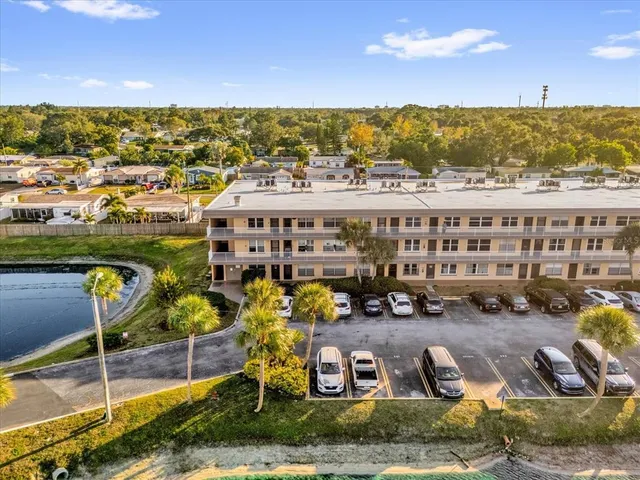 an aerial view of residential building and lake