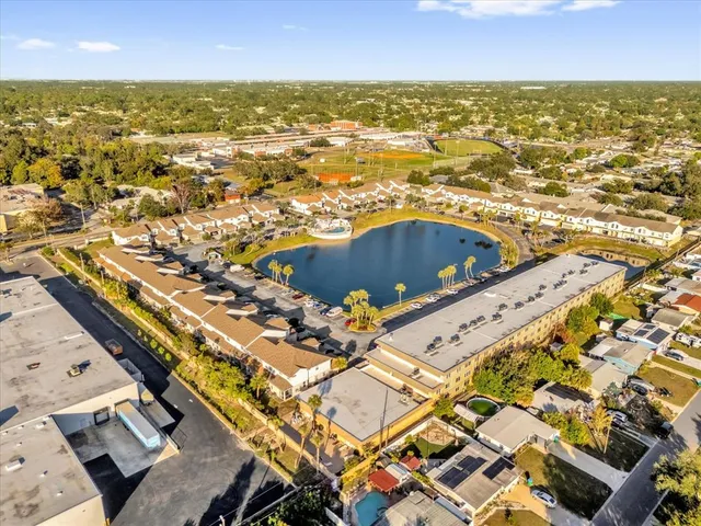 an aerial view of residential houses with outdoor space and ocean view