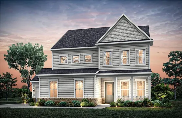 a view of a white house with large windows and a yard