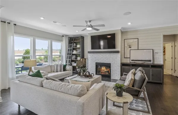 a living room with furniture fireplace and flat screen tv