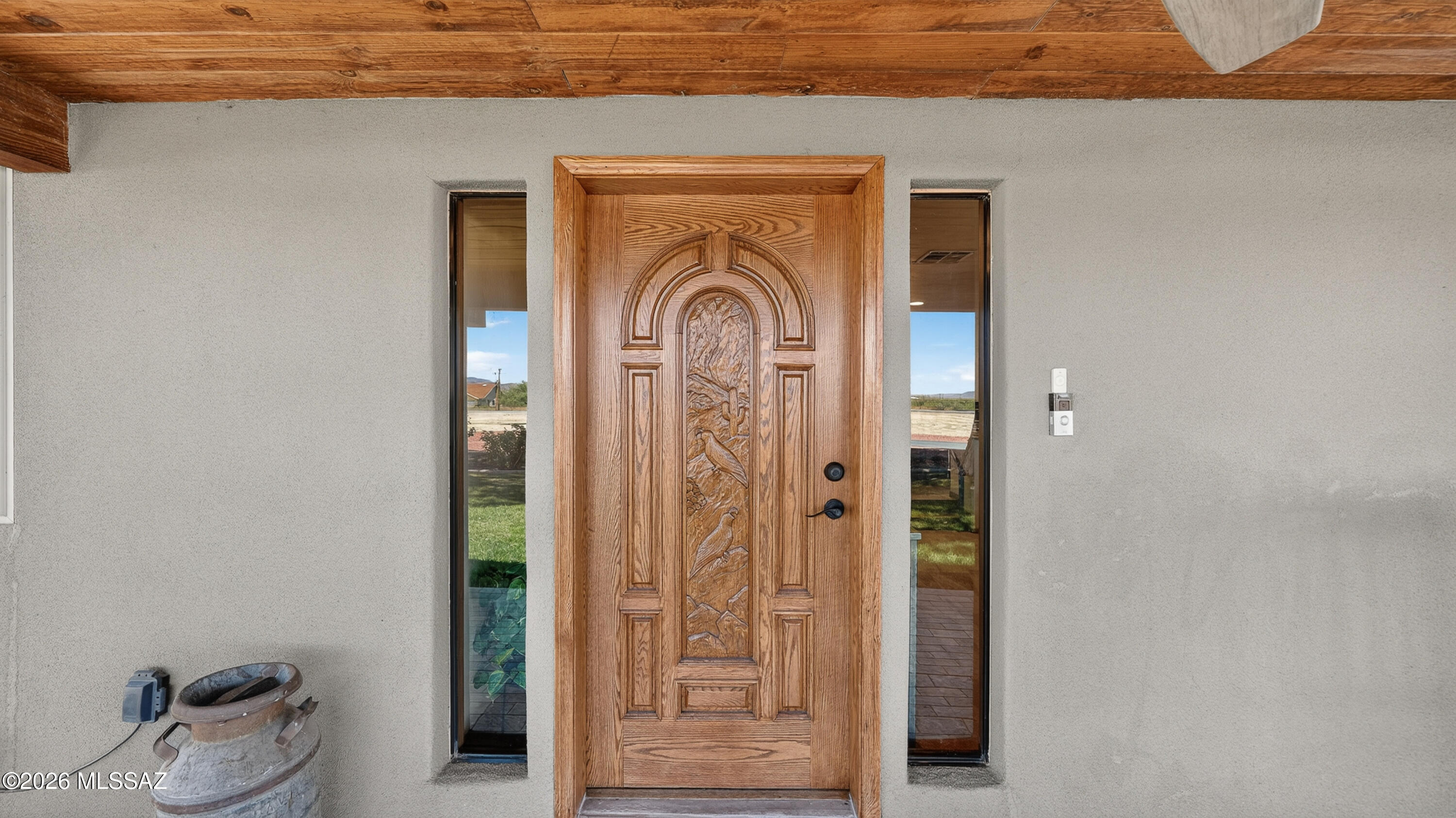 194 Taylor Road Willcox, AZ 85643 - Photo 10 of 54 beautiful front entry with a covered tiled porch, custom wood front door featuring a hand-carved quail detail, Dual Sidelights, Freshly refinished 6/26