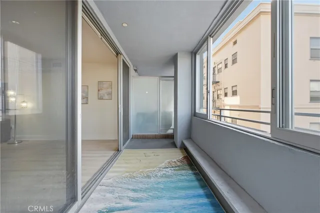 a view of hallway with windows and wooden floor