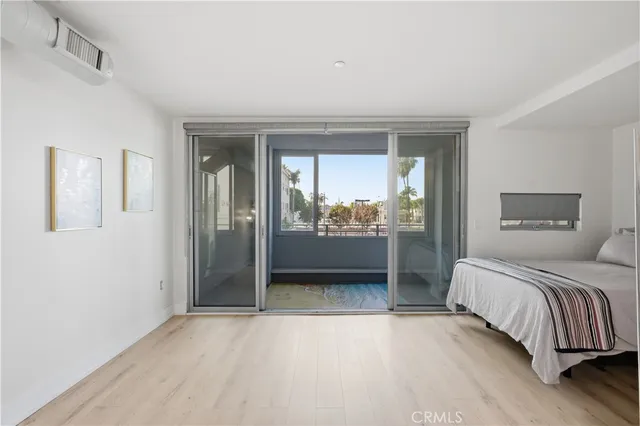 a bedroom with a bed and a mirror