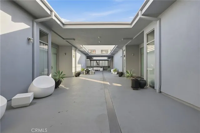 a view of a patio with table and chairs and potted plants
