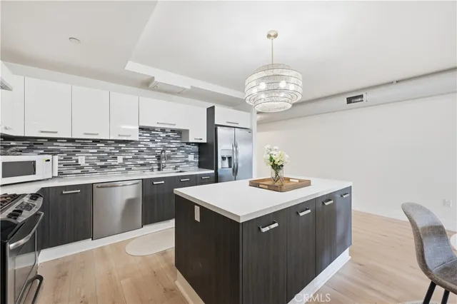 a kitchen with a stove a sink a dining table and chairs