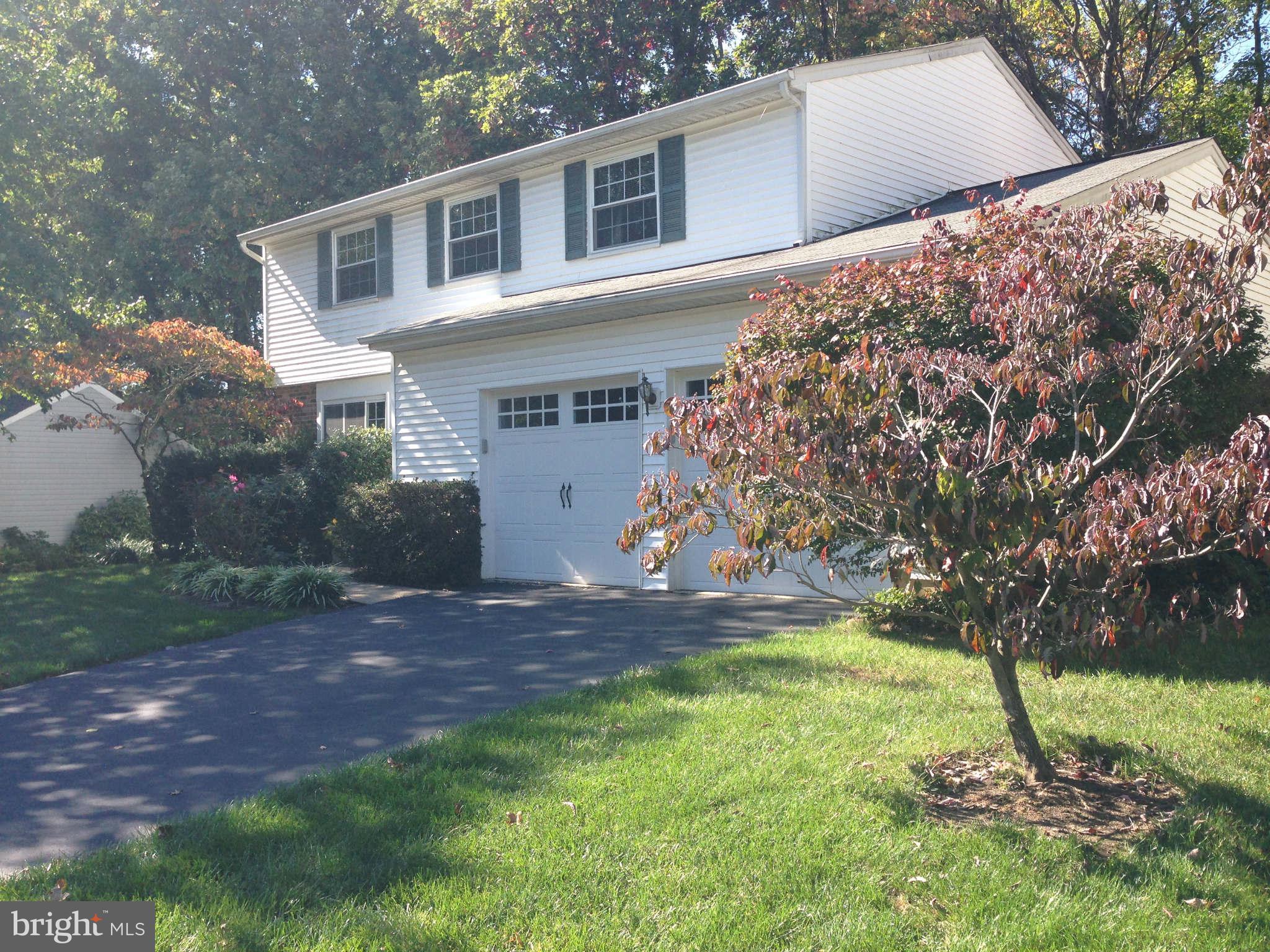 8066 Athena Street Springfield, VA 22153 - Photo 2 of 30 a front view of a house with a yard