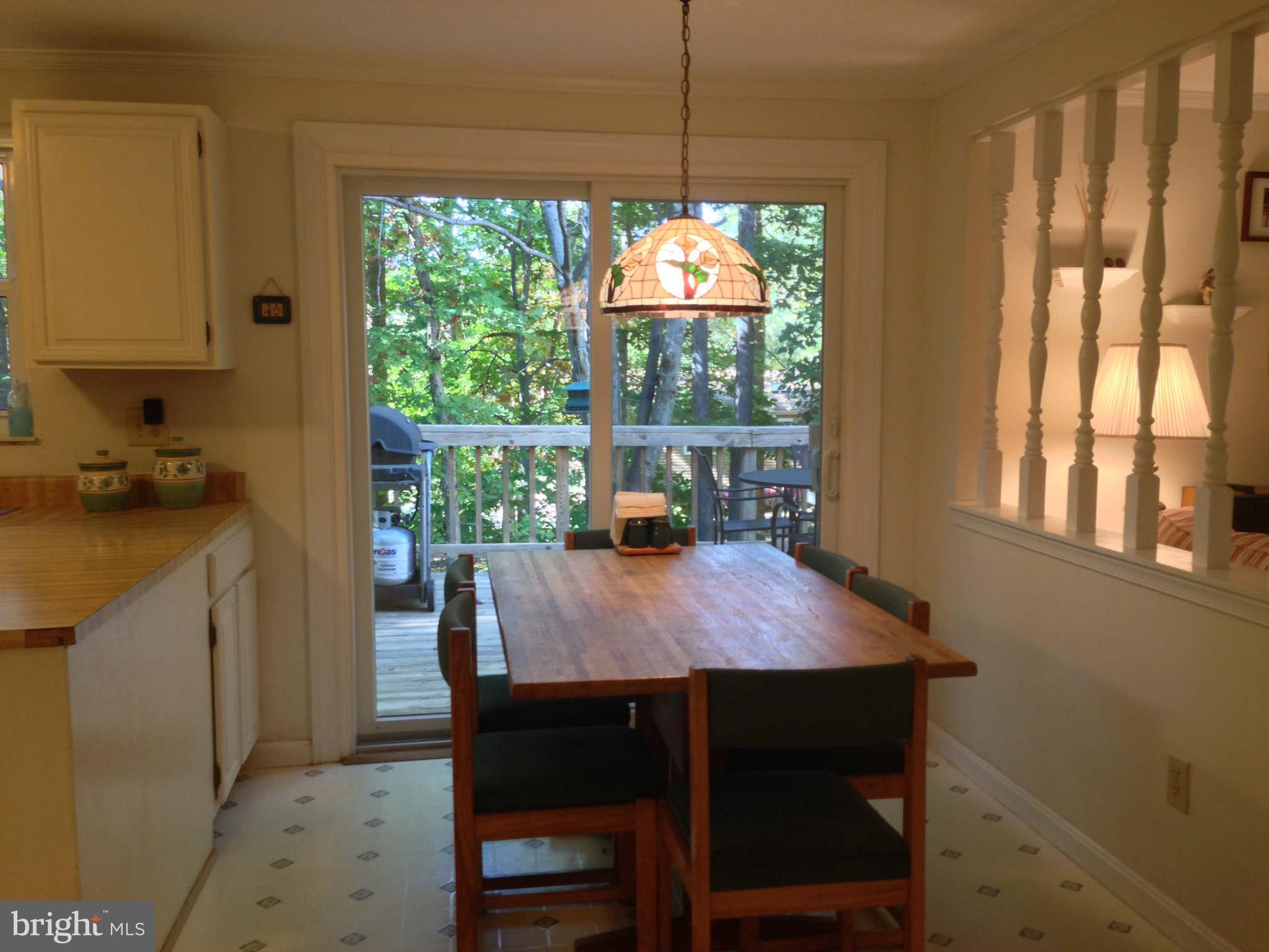 8066 Athena Street Springfield, VA 22153 - Photo 12 of 30 a dining room with furniture a chandelier and window