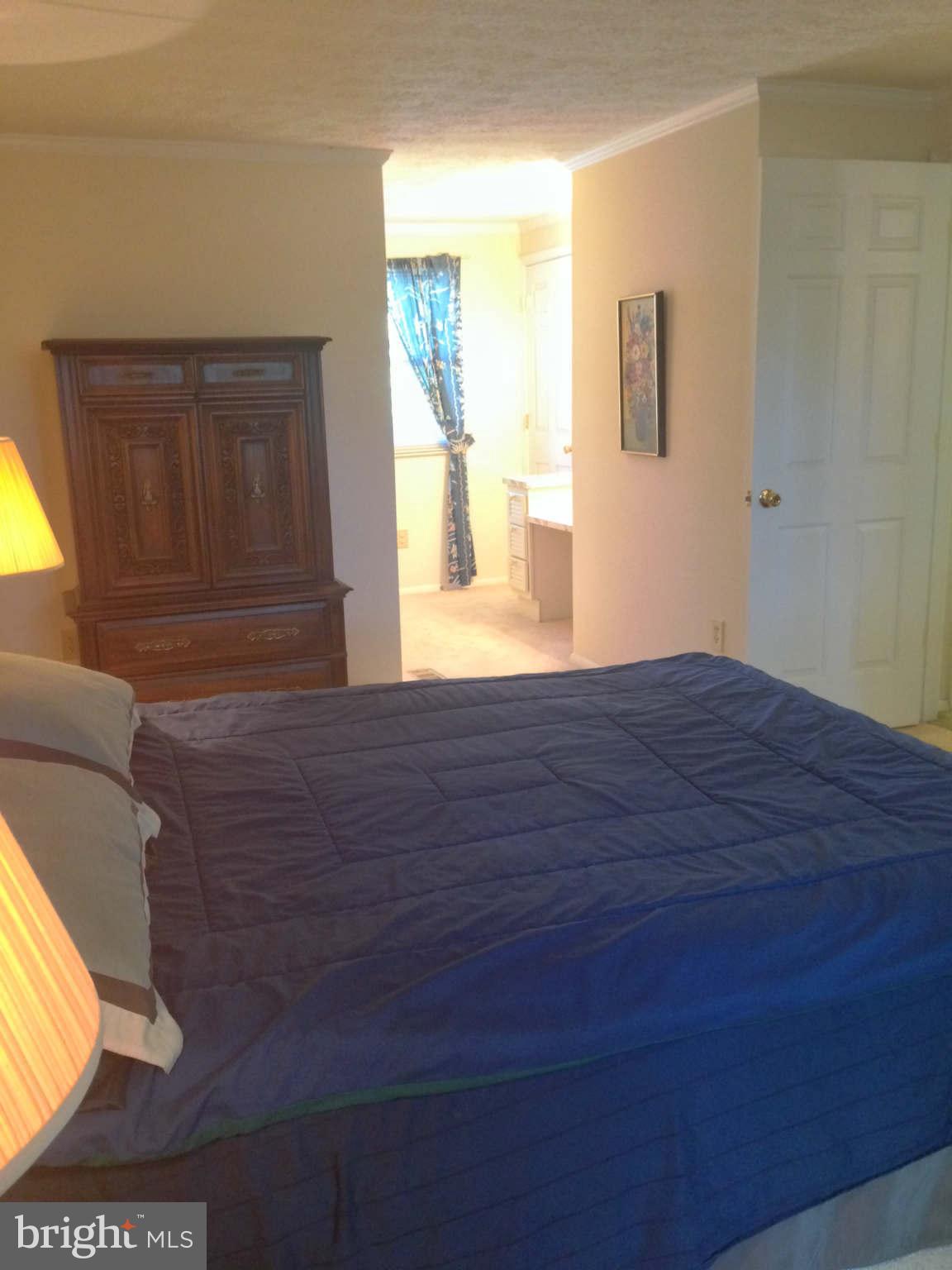 8066 Athena Street Springfield, VA 22153 - Photo 17 of 30 a view of an empty room with wooden floor and a window