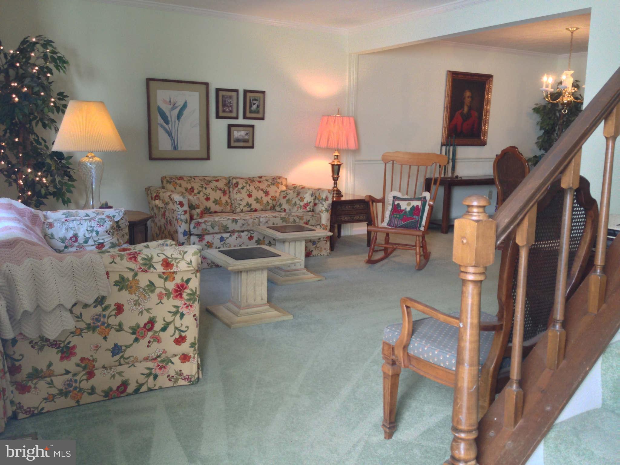 8066 Athena Street Springfield, VA 22153 - Photo 3 of 30 a living room with furniture and a lamp