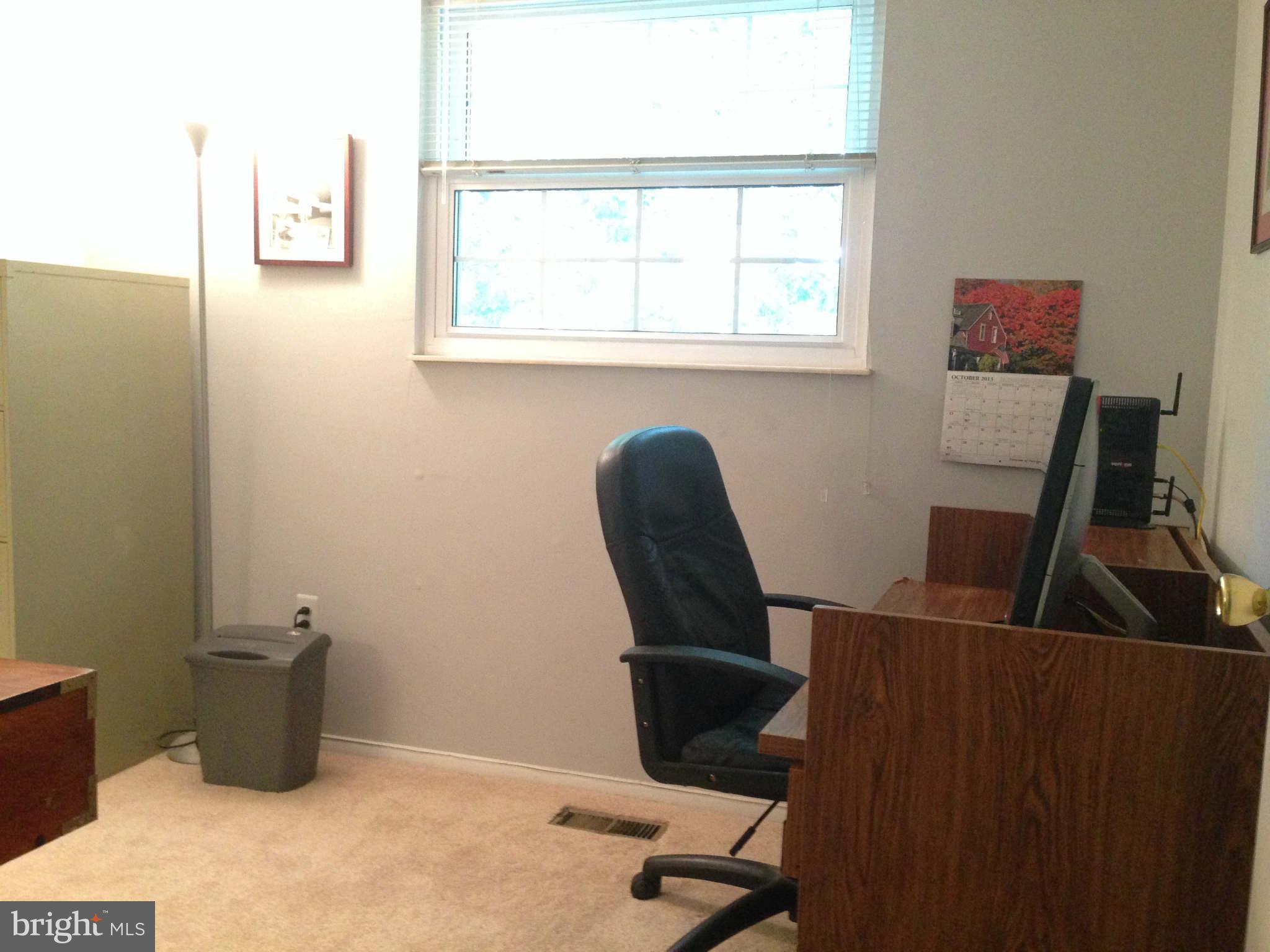 8066 Athena Street Springfield, VA 22153 - Photo 23 of 30 a view of a workspace with furniture and a window