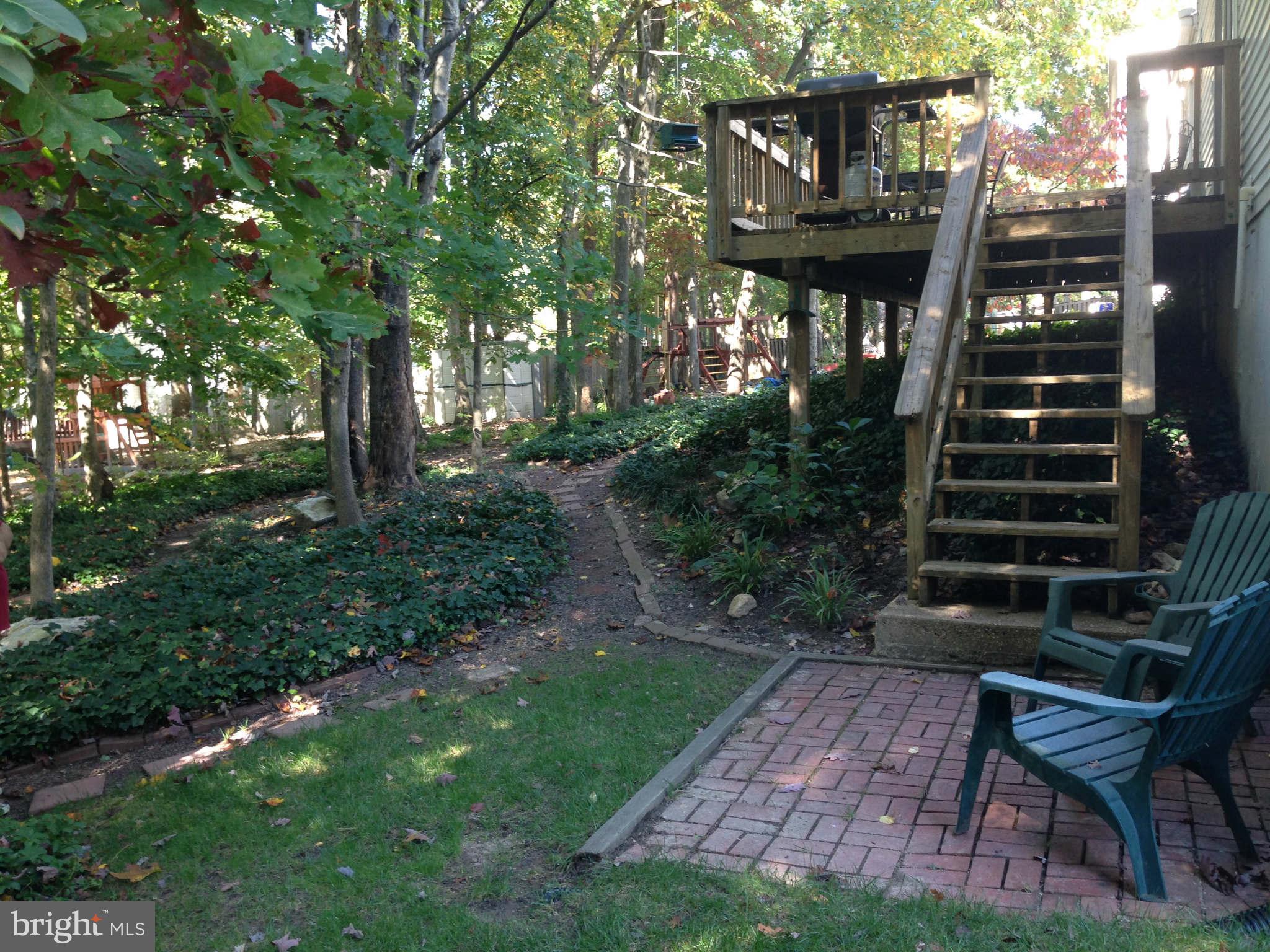 8066 Athena Street Springfield, VA 22153 - Photo 28 of 30 a view of a house with backyard and sitting area