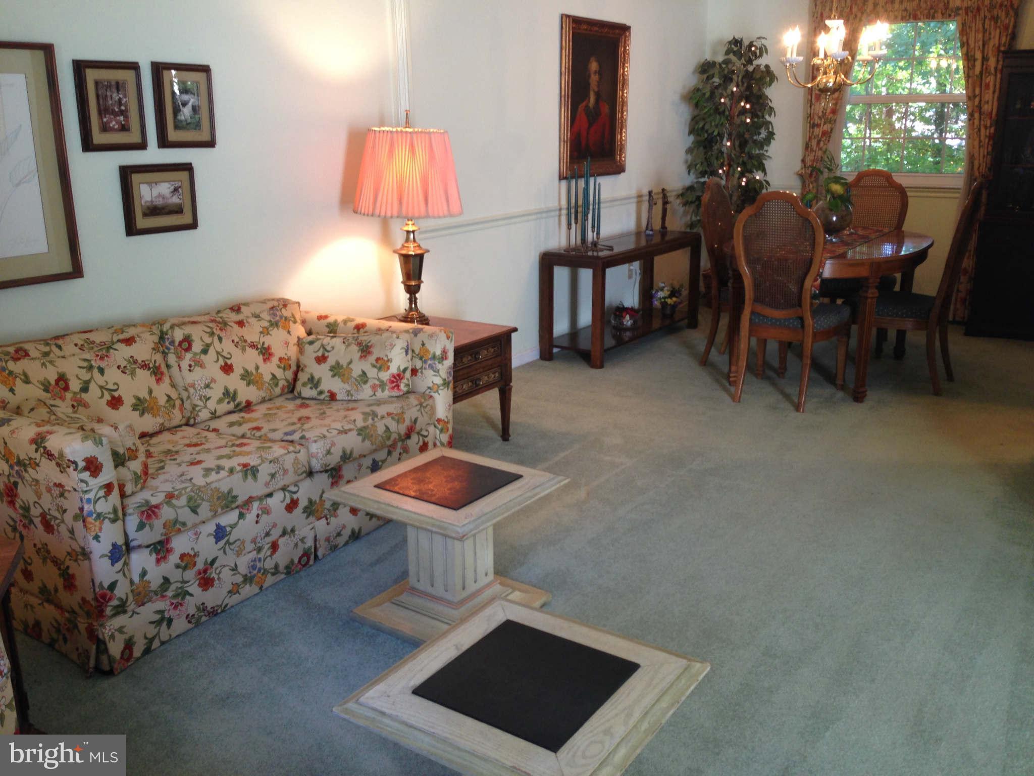 8066 Athena Street Springfield, VA 22153 - Photo 4 of 30 a living room with furniture and a lamp