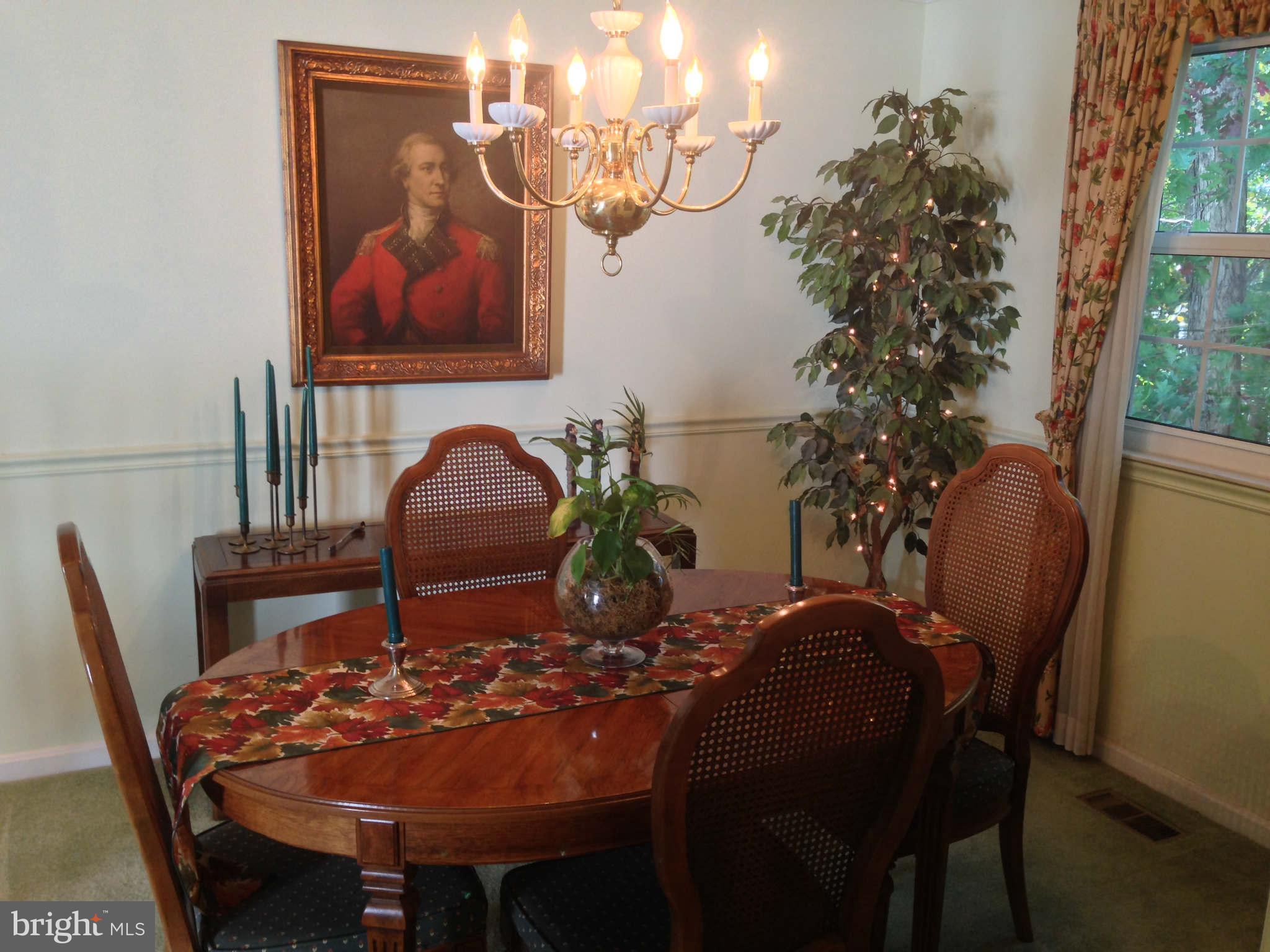 8066 Athena Street Springfield, VA 22153 - Photo 6 of 30 a view of a dining room with furniture and chandelier