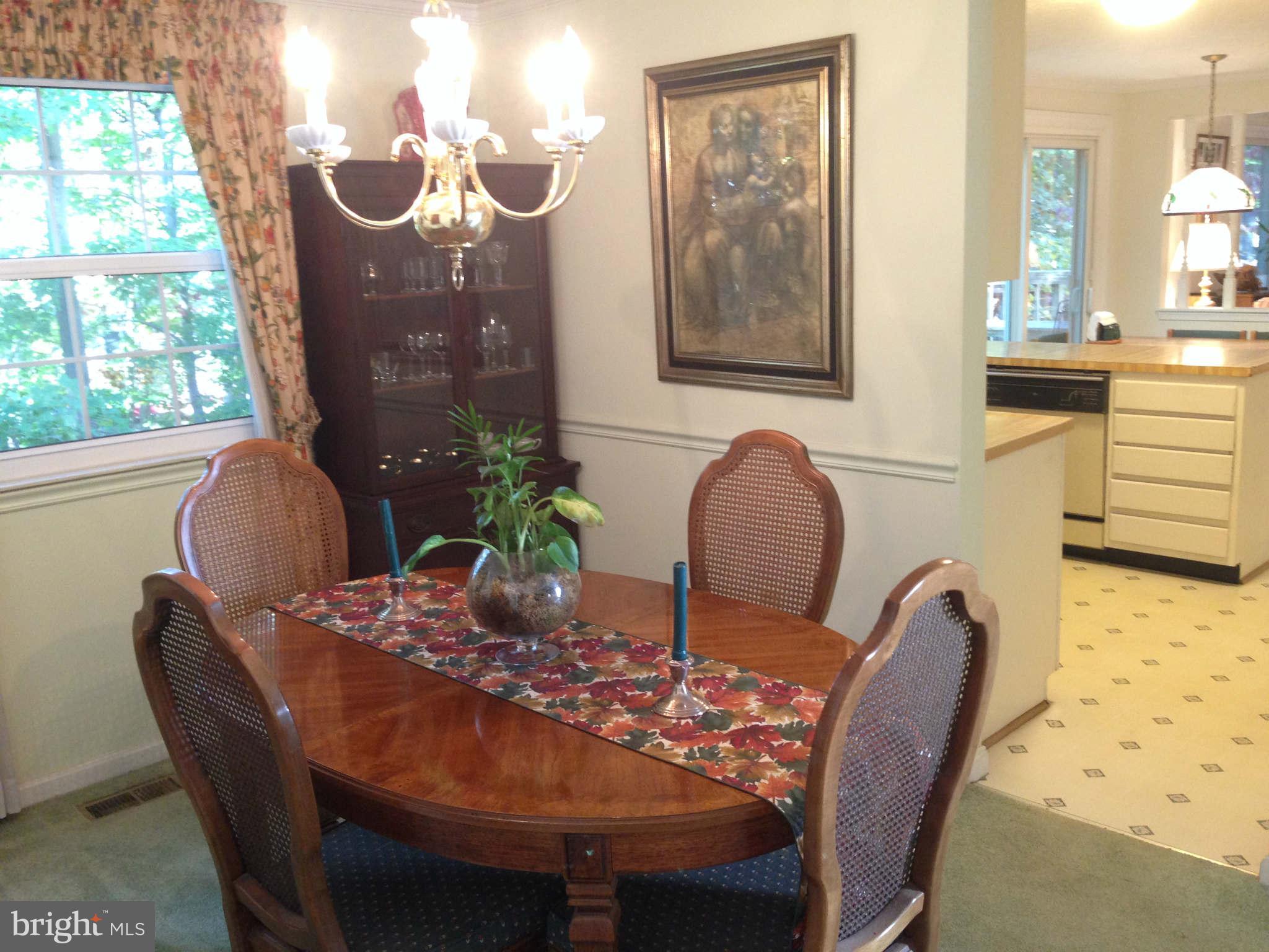 8066 Athena Street Springfield, VA 22153 - Photo 7 of 30 a view of a dining room with furniture window and outside view
