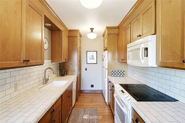 a kitchen with a sink stove and cabinets