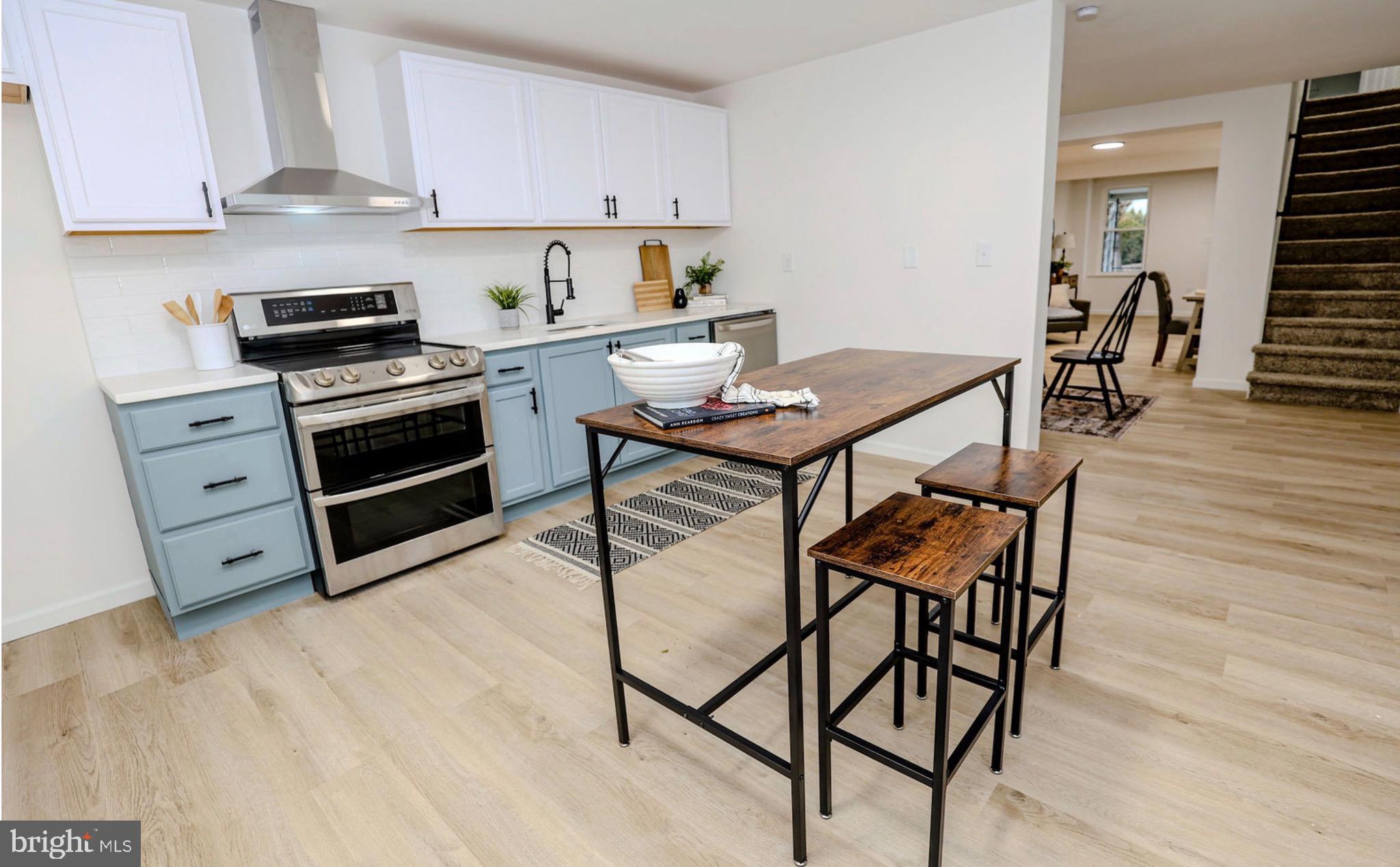 1234 Main Street Harrisburg, PA 17113 - Photo 16 of 36 a kitchen with stainless steel appliances kitchen island granite countertop a stove a sink and a refrigerator