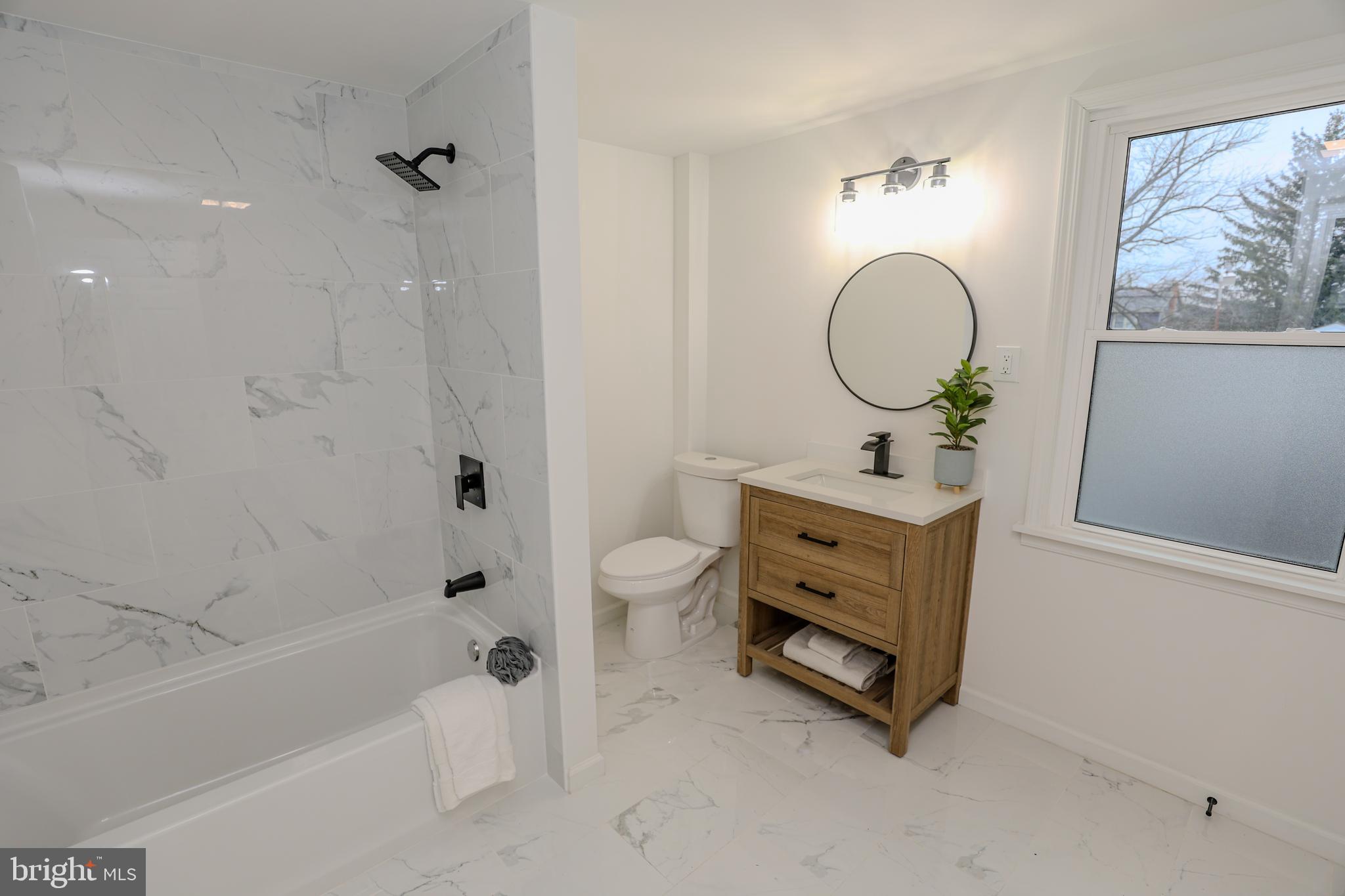 1234 Main Street Harrisburg, PA 17113 - Photo 25 of 36 a bathroom with a double vanity sink toilet mirror and bathtub