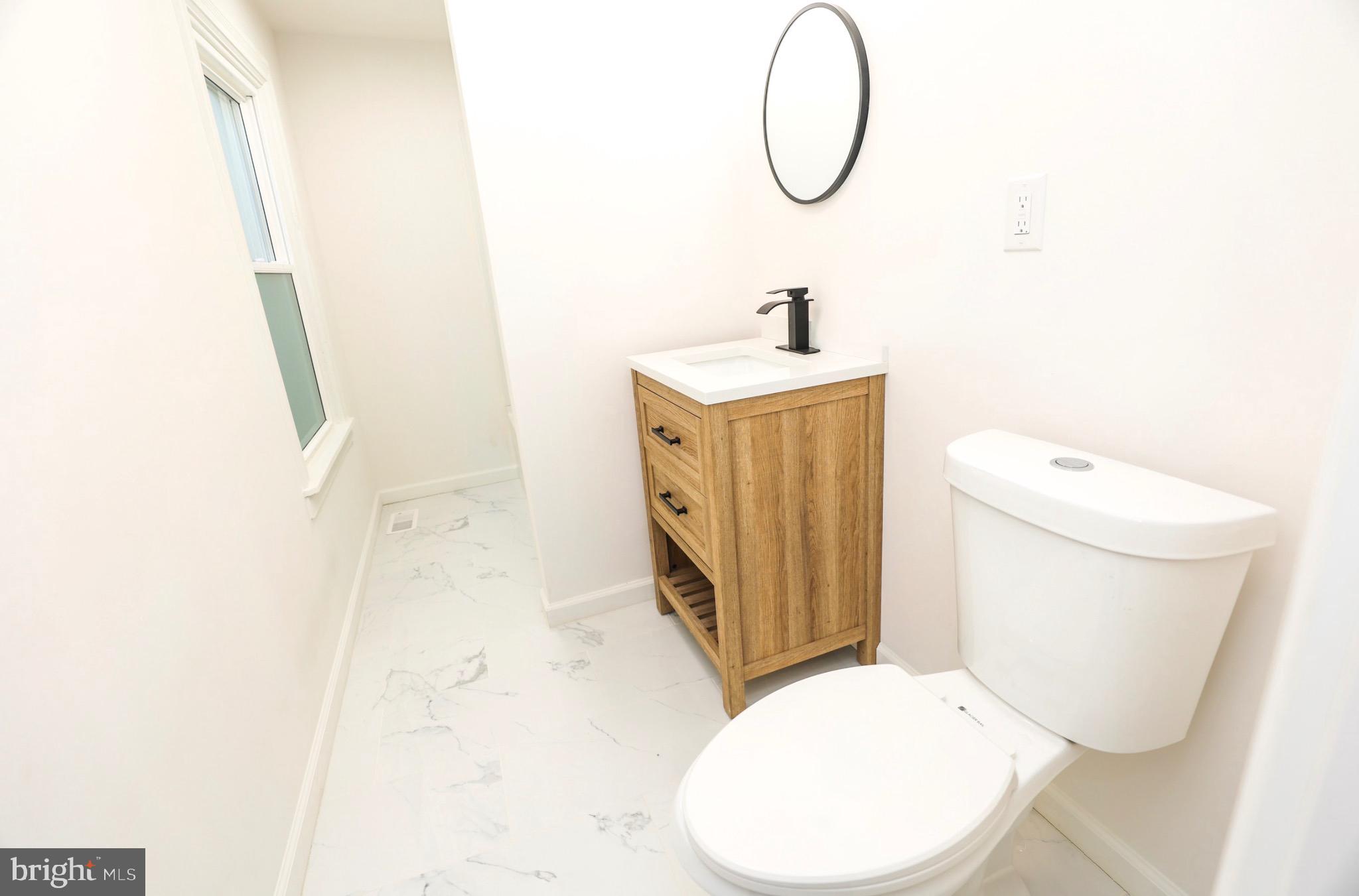 1234 Main Street Harrisburg, PA 17113 - Photo 33 of 36 a bathroom with a toilet sink and mirror