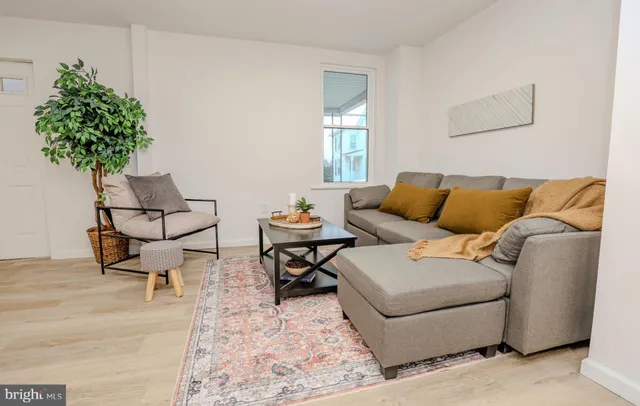 a living room with a couch and a rug