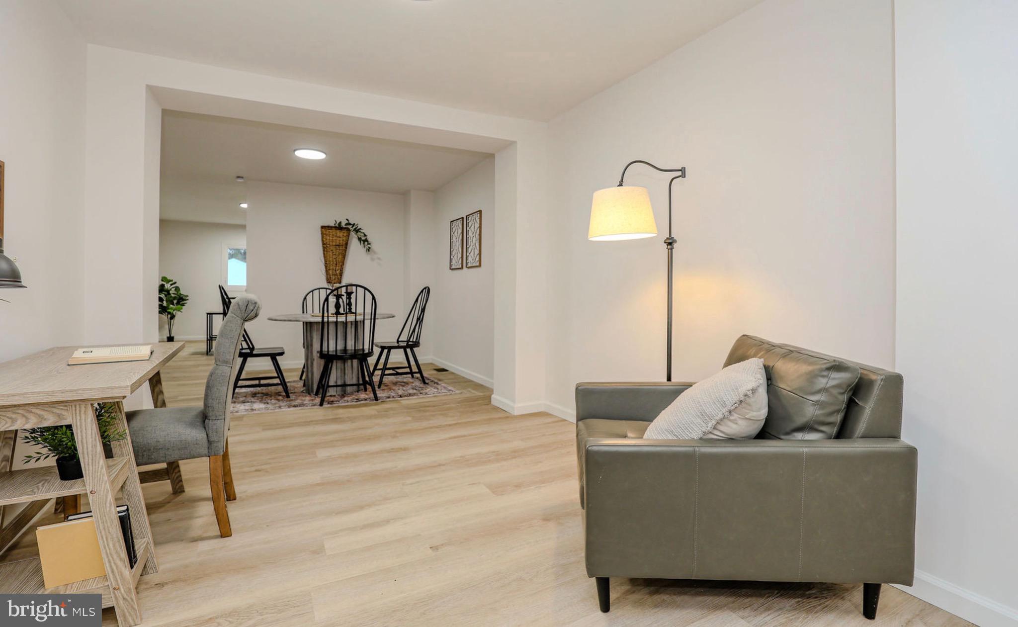 1234 Main Street Harrisburg, PA 17113 - Photo 10 of 36 a living room with furniture and a dining table with wooden floor