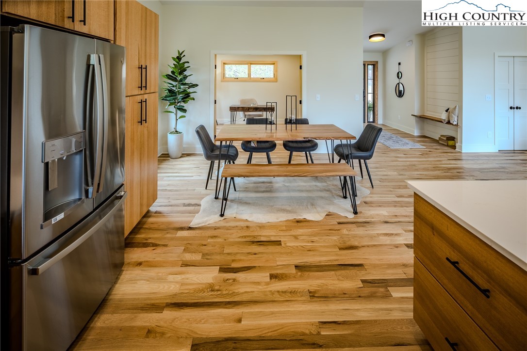 281 New Riv Farms Road Fleetwood, NC 28626 - Photo 17 of 50 a living room with furniture wooden floor and a large window
