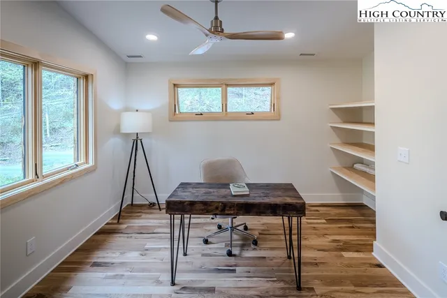 a view of balcony with wooden floor and fence