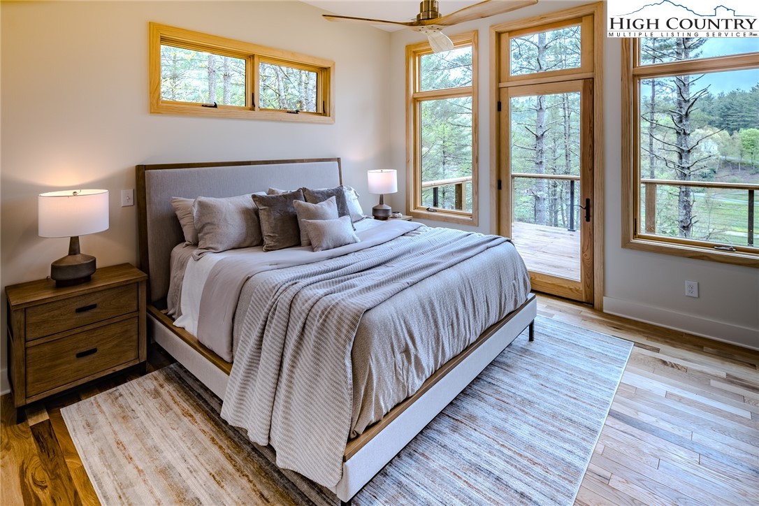 281 New Riv Farms Road Fleetwood, NC 28626 - Photo 23 of 50 a large bed sitting in a bedroom next to a window