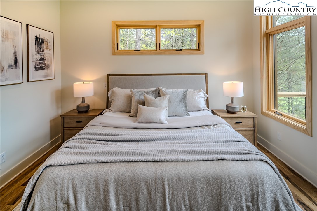 281 New Riv Farms Road Fleetwood, NC 28626 - Photo 24 of 50 a spacious bedroom with a bed and a large window